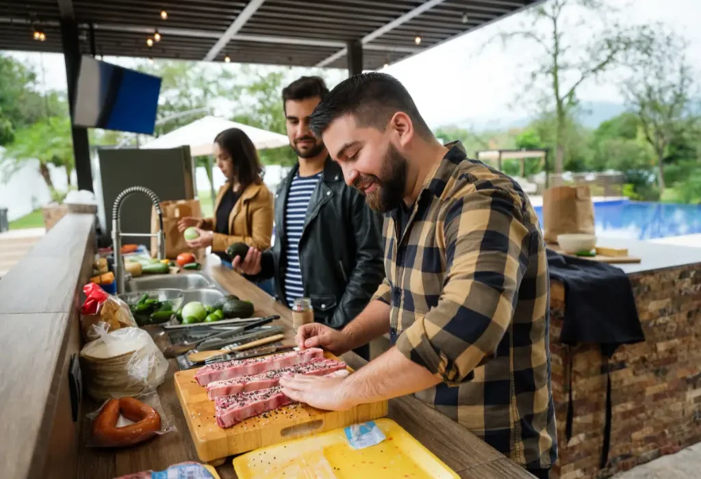 friends prepping food in an outdoor kitchen